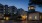 a building at dusk with trees