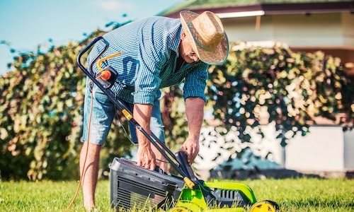 a man using a lawnmower