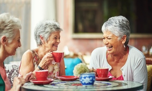 women laughing and drinking