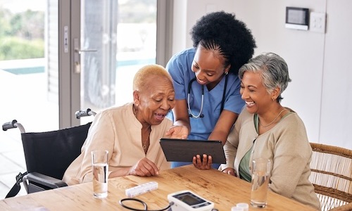 three women looking at a device