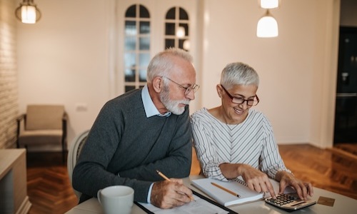 a couple looking at a calculator