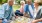 Two senior couples enjoying a picnic in a park